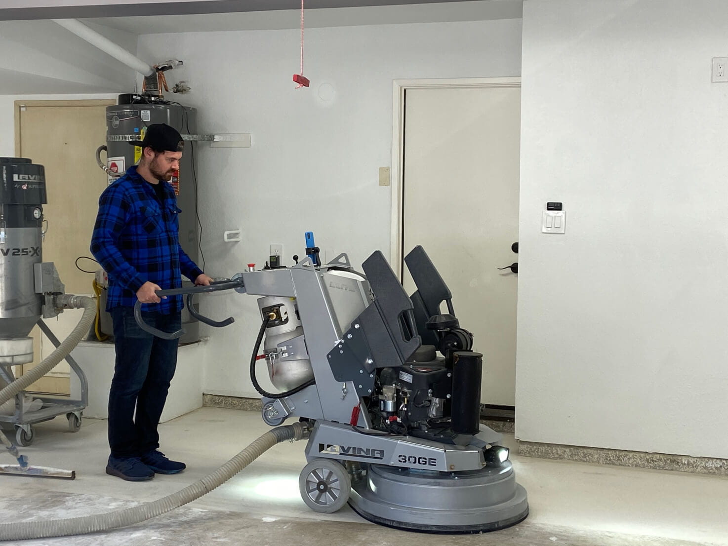 Evan Beckerman helping to prep the garage floor for LATICRETE resinous coatings